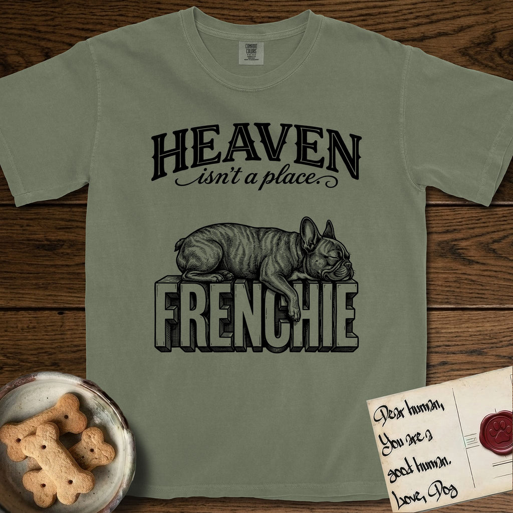 Heaven Isn't a Place French Bulldog T-Shirt flat lay in Sage, featuring Black ink engraving illustration of a brindle French Bulldog asleep on top of the giant carved block letters FRENCHIE, under the lettering HEAVEN isn't a place..