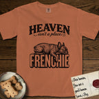 Heaven Isn't a Place French Bulldog T-Shirt flat lay in Yam, featuring Black ink engraving illustration of a brindle French Bulldog asleep on top of the giant carved block letters FRENCHIE, under the lettering HEAVEN isn't a place..