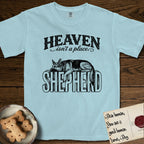 Heaven Isn't a Place German Shepherd T-Shirt flat lay in Chambray, featuring Black ink engraving illustration of a German Shepherd asleep on top of the giant carved block letters SHEPHERD, under the lettering HEAVEN isn't a place..