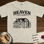 Heaven Isn't a Place German Shepherd T-Shirt flat lay in Ivory, featuring Black ink engraving illustration of a German Shepherd asleep on top of the giant carved block letters SHEPHERD, under the lettering HEAVEN isn't a place..