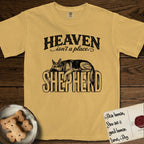 Heaven Isn't a Place German Shepherd T-Shirt flat lay in Mustard, featuring Black ink engraving illustration of a German Shepherd asleep on top of the giant carved block letters SHEPHERD, under the lettering HEAVEN isn't a place..