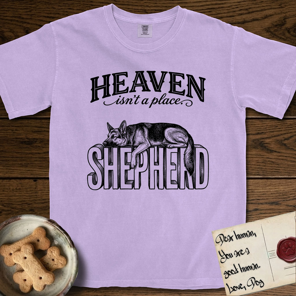 Heaven Isn't a Place German Shepherd T-Shirt flat lay in Orchid, featuring Black ink engraving illustration of a German Shepherd asleep on top of the giant carved block letters SHEPHERD, under the lettering HEAVEN isn't a place..