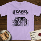 Heaven Isn't a Place German Shepherd T-Shirt flat lay in Orchid, featuring Black ink engraving illustration of a German Shepherd asleep on top of the giant carved block letters SHEPHERD, under the lettering HEAVEN isn't a place..