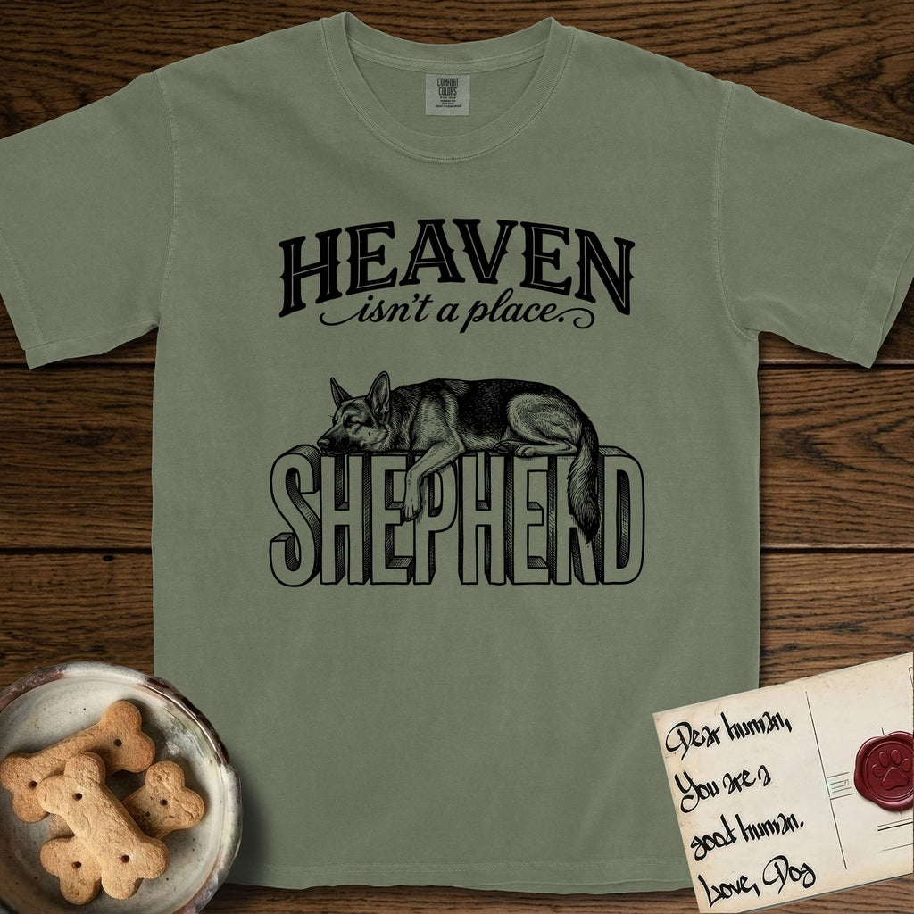 Heaven Isn't a Place German Shepherd T-Shirt flat lay in Sage, featuring Black ink engraving illustration of a German Shepherd asleep on top of the giant carved block letters SHEPHERD, under the lettering HEAVEN isn't a place..