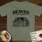 Heaven Isn't a Place German Shepherd T-Shirt flat lay in Sage, featuring Black ink engraving illustration of a German Shepherd asleep on top of the giant carved block letters SHEPHERD, under the lettering HEAVEN isn't a place..