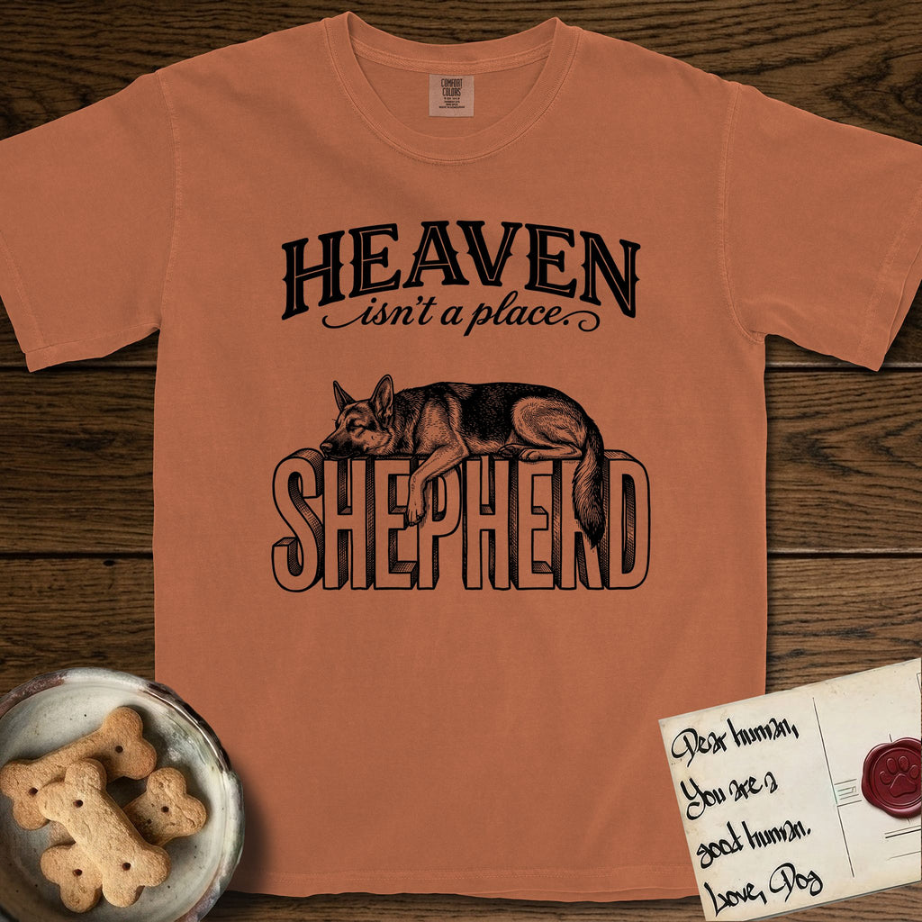 Heaven Isn't a Place German Shepherd T-Shirt flat lay in Yam, featuring Black ink engraving illustration of a German Shepherd asleep on top of the giant carved block letters SHEPHERD, under the lettering HEAVEN isn't a place..