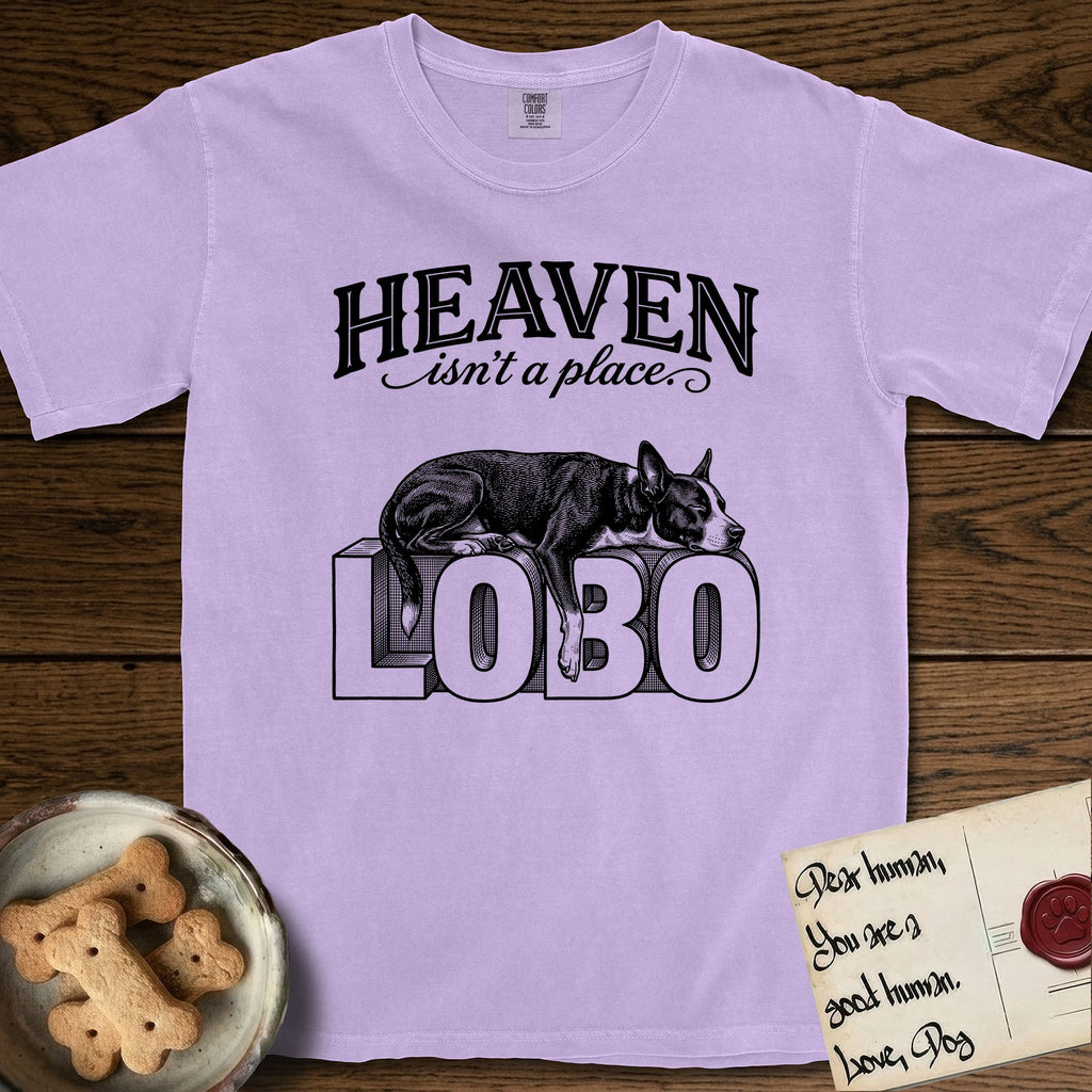 Heaven Isn't a Place Lobo T-Shirt flat lay in Orchid, featuring Black ink engraving illustration of Lobo, a black-and-white Cattle Dog and Pitbull mix with a white blaze, asleep on top of the giant carved block letters LOBO, under the lettering HEAVEN isn't a place..