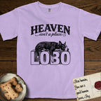 Heaven Isn't a Place Lobo T-Shirt flat lay in Orchid, featuring Black ink engraving illustration of Lobo, a black-and-white Cattle Dog and Pitbull mix with a white blaze, asleep on top of the giant carved block letters LOBO, under the lettering HEAVEN isn't a place..