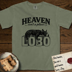 Heaven Isn't a Place Lobo T-Shirt flat lay in Sage, featuring Black ink engraving illustration of Lobo, a black-and-white Cattle Dog and Pitbull mix with a white blaze, asleep on top of the giant carved block letters LOBO, under the lettering HEAVEN isn't a place..