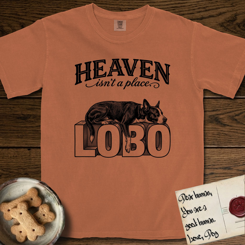 Heaven Isn't a Place Lobo T-Shirt flat lay in Yam, featuring Black ink engraving illustration of Lobo, a black-and-white Cattle Dog and Pitbull mix with a white blaze, asleep on top of the giant carved block letters LOBO, under the lettering HEAVEN isn't a place..