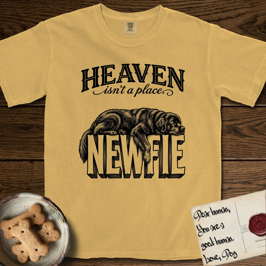 Heaven Isn't a Place Newfoundland T-Shirt flat lay in Mustard, featuring Black ink engraving illustration of a Newfoundland asleep on top of the giant carved block letters NEWFIE, under the lettering HEAVEN isn't a place..