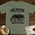 Heaven Isn't a Place Newfoundland T-Shirt flat lay in Sage, featuring Black ink engraving illustration of a Newfoundland asleep on top of the giant carved block letters NEWFIE, under the lettering HEAVEN isn't a place..