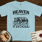 Heaven Isn't a Place Pitbull T-Shirt flat lay in Chambray, featuring Black ink engraving illustration of a Pitbull asleep on top of the giant carved block letters PITBULL, under the lettering HEAVEN isn't a place..