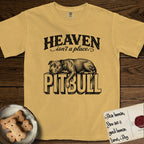 Heaven Isn't a Place Pitbull T-Shirt flat lay in Mustard, featuring Black ink engraving illustration of a Pitbull asleep on top of the giant carved block letters PITBULL, under the lettering HEAVEN isn't a place..