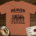Heaven Isn't a Place Pitbull T-Shirt flat lay in Yam, featuring Black ink engraving illustration of a Pitbull asleep on top of the giant carved block letters PITBULL, under the lettering HEAVEN isn't a place..