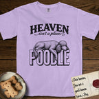 Heaven Isn't a Place Poodle T-Shirt flat lay in Orchid, featuring Black ink engraving illustration of a curly Standard Poodle asleep on top of the giant carved block letters POODLE, under the lettering HEAVEN isn't a place..