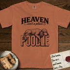 Heaven Isn't a Place Poodle T-Shirt flat lay in Yam, featuring Black ink engraving illustration of a curly Standard Poodle asleep on top of the giant carved block letters POODLE, under the lettering HEAVEN isn't a place..