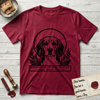 Holy Orders Beagle T-Shirt flat lay in Antique Cherry Red, featuring a bold black-and-white linocut saint-medallion portrait of a Beagle.