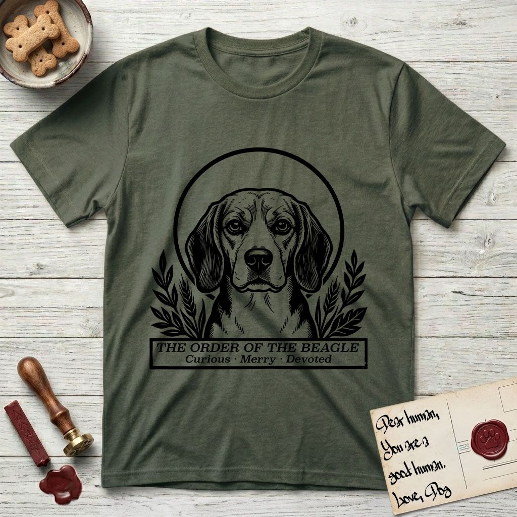 Holy Orders Beagle T-Shirt flat lay in Heather Military Green, featuring a bold black-and-white linocut saint-medallion portrait of a Beagle.