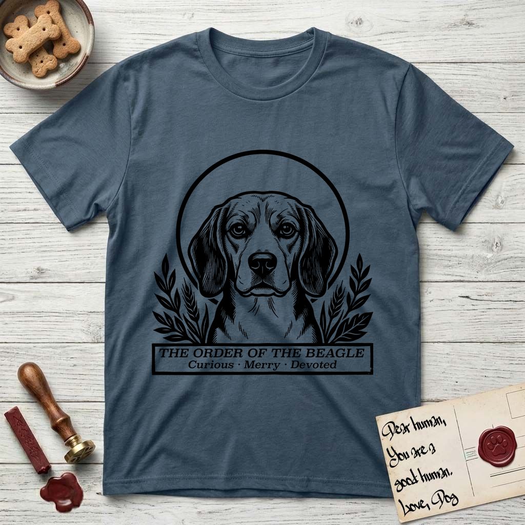 Holy Orders Beagle T-Shirt flat lay in Indigo Blue, featuring a bold black-and-white linocut saint-medallion portrait of a Beagle.