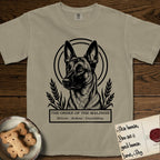 Holy Orders Belgian Malinois T-Shirt flat lay in Khaki, featuring a bold black-and-white linocut saint-medallion portrait of a Belgian Malinois.