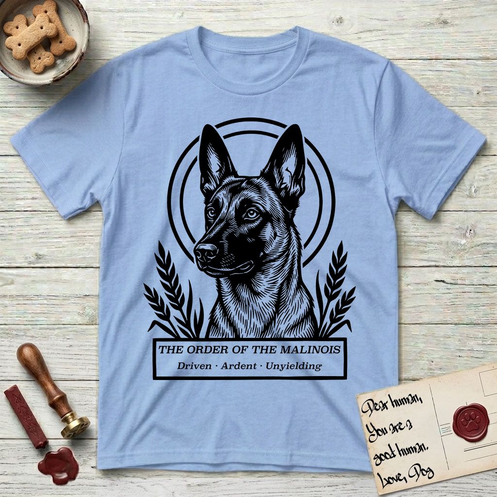 Holy Orders Belgian Malinois T-Shirt flat lay in Light Blue, featuring a bold black-and-white linocut saint-medallion portrait of a Belgian Malinois.