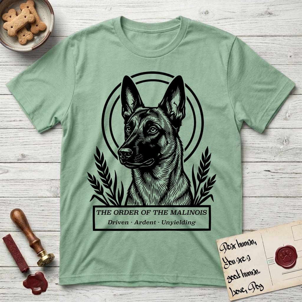 Holy Orders Belgian Malinois T-Shirt flat lay in Mint Green, featuring a bold black-and-white linocut saint-medallion portrait of a Belgian Malinois.