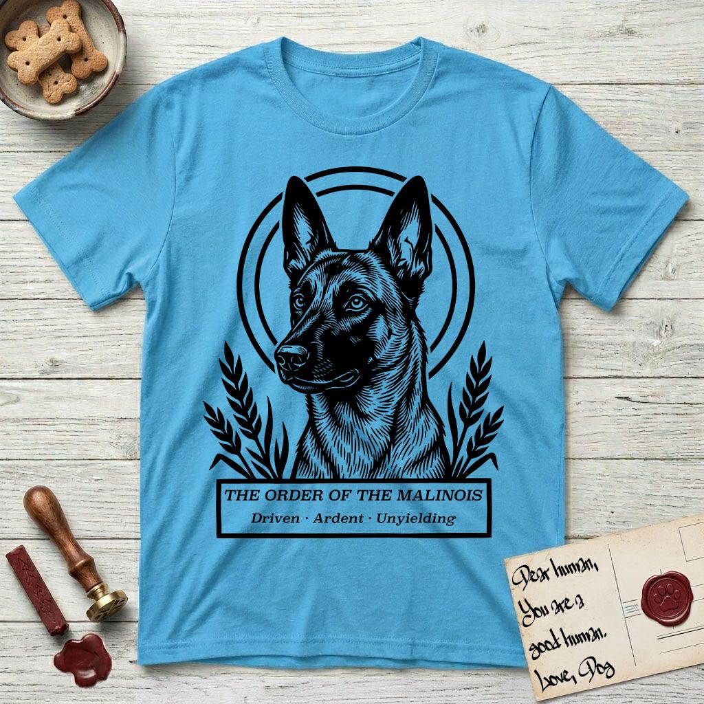 Holy Orders Belgian Malinois T-Shirt flat lay in Sky, featuring a bold black-and-white linocut saint-medallion portrait of a Belgian Malinois.