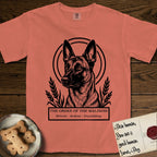 Holy Orders Belgian Malinois T-Shirt flat lay in Terracotta, featuring a bold black-and-white linocut saint-medallion portrait of a Belgian Malinois.