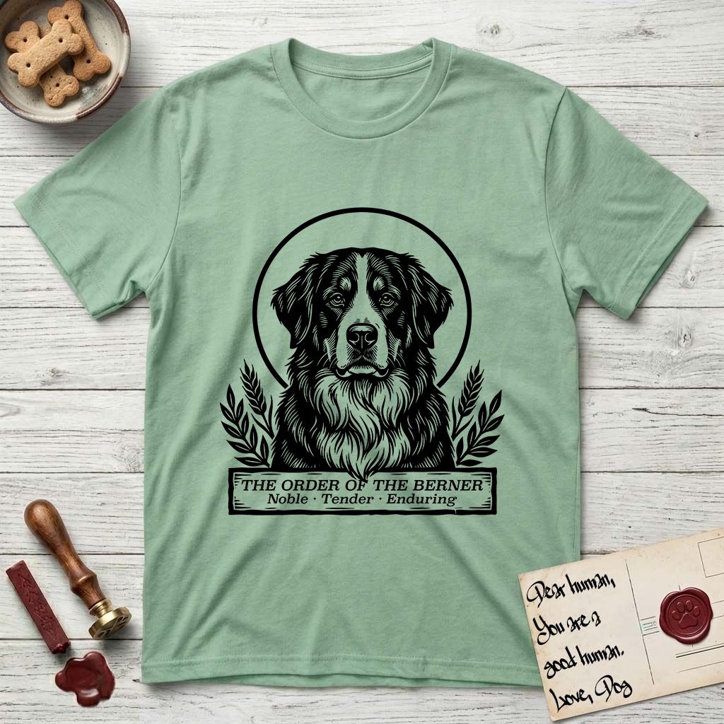 Holy Orders Bernese Mountain Dog T-Shirt flat lay in Mint Green, featuring a bold black-and-white linocut saint-medallion portrait of a Bernese Mountain Dog.