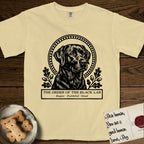 Holy Orders Black Lab T-Shirt flat lay in Butter, featuring a bold black-and-white linocut saint-medallion portrait of a Black Lab.