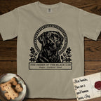 Holy Orders Black Lab T-Shirt flat lay in Khaki, featuring a bold black-and-white linocut saint-medallion portrait of a Black Lab.