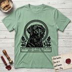 Holy Orders Black Lab T-Shirt flat lay in Mint Green, featuring a bold black-and-white linocut saint-medallion portrait of a Black Lab.