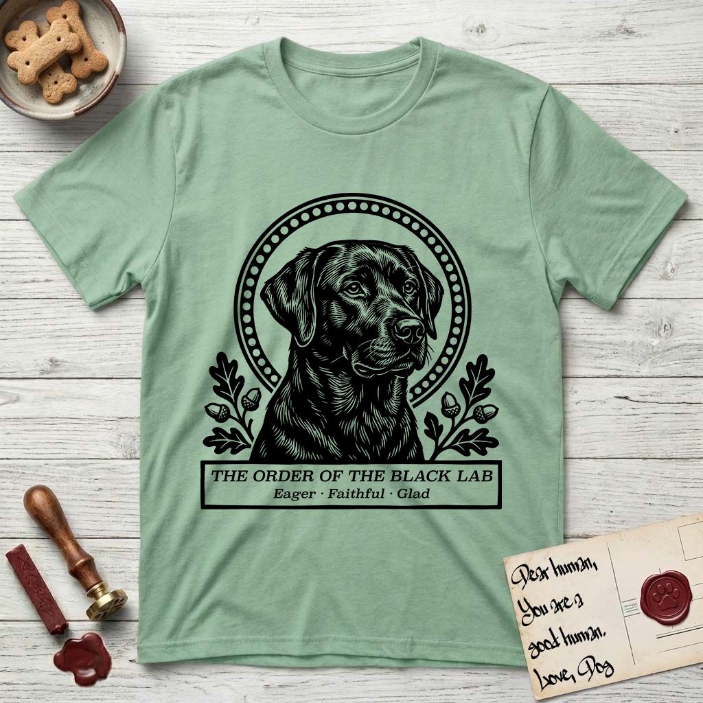 Holy Orders Black Lab T-Shirt flat lay in Mint Green, featuring a bold black-and-white linocut saint-medallion portrait of a Black Lab.