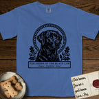 Holy Orders Black Lab T-Shirt flat lay in Mystic Blue, featuring a bold black-and-white linocut saint-medallion portrait of a Black Lab.