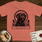 Holy Orders Black Lab T-Shirt flat lay in Terracotta, featuring a bold black-and-white linocut saint-medallion portrait of a Black Lab.