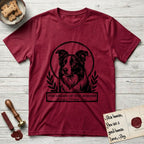 Holy Orders Border Collie T-Shirt flat lay in Antique Cherry Red, featuring a bold black-and-white linocut saint-medallion portrait of a Border Collie.