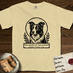 Holy Orders Border Collie T-Shirt flat lay in Butter, featuring a bold black-and-white linocut saint-medallion portrait of a Border Collie.