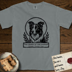Holy Orders Border Collie T-Shirt flat lay in Granite, featuring a bold black-and-white linocut saint-medallion portrait of a Border Collie.
