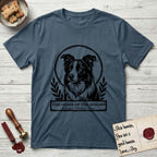 Holy Orders Border Collie T-Shirt flat lay in Indigo Blue, featuring a bold black-and-white linocut saint-medallion portrait of a Border Collie.