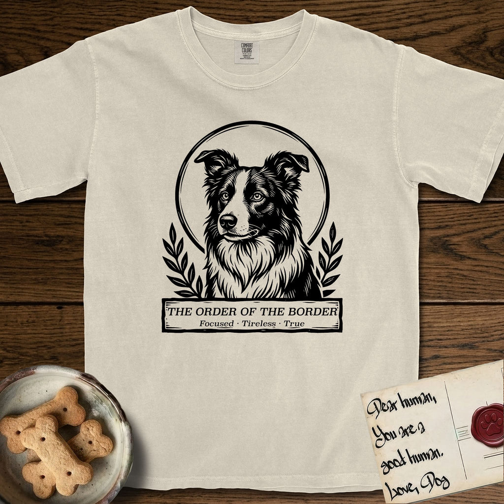 Holy Orders Border Collie T-Shirt flat lay in Ivory, featuring a bold black-and-white linocut saint-medallion portrait of a Border Collie.