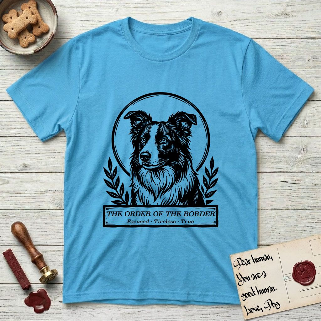 Holy Orders Border Collie T-Shirt flat lay in Sky, featuring a bold black-and-white linocut saint-medallion portrait of a Border Collie.