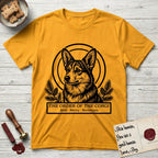 Holy Orders Corgi T-Shirt flat lay in Gold, featuring a bold black-and-white linocut saint-medallion portrait of a Corgi.