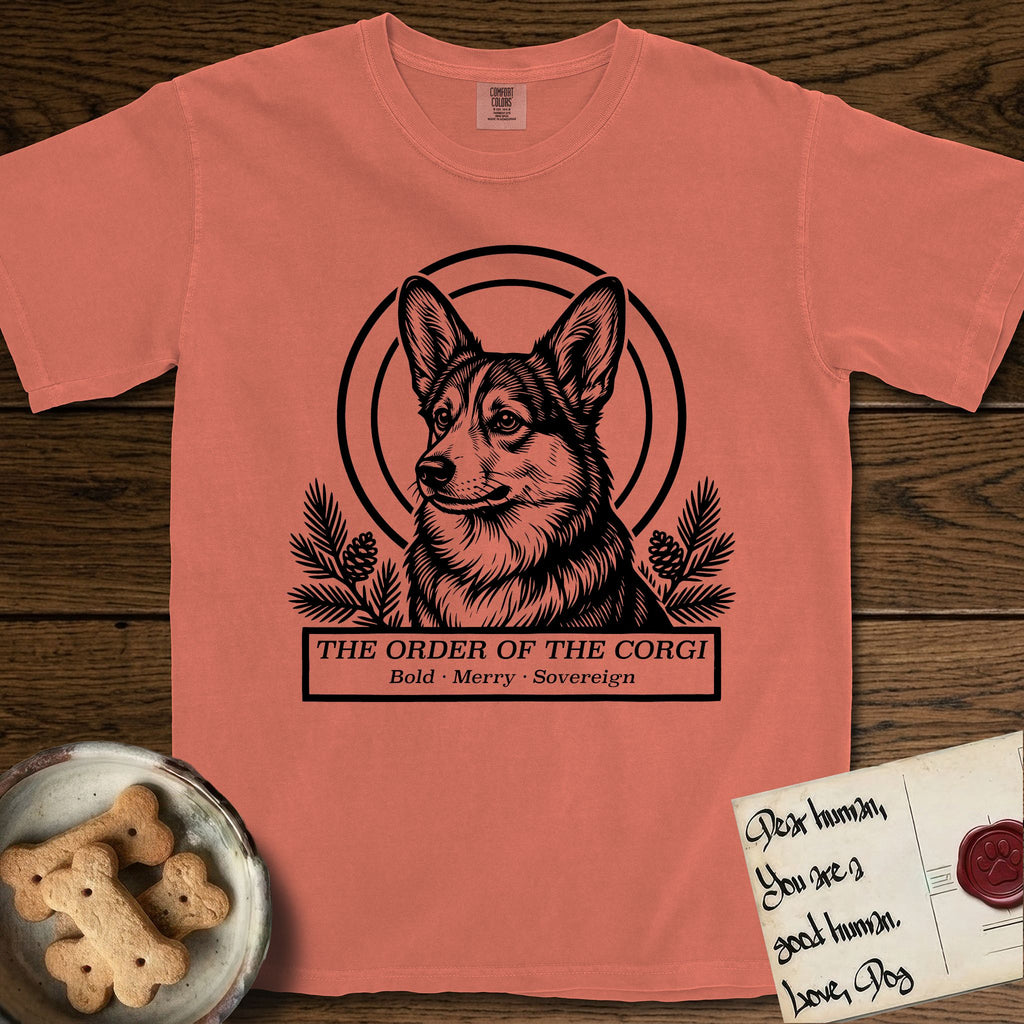 Holy Orders Corgi T-Shirt flat lay in Terracotta, featuring a bold black-and-white linocut saint-medallion portrait of a Corgi.