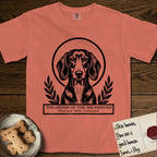 Holy Orders Dachshund T-Shirt flat lay in Terracotta, featuring a bold black-and-white linocut saint-medallion portrait of a Dachshund.