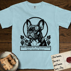 Holy Orders French Bulldog T-Shirt flat lay in Chambray, featuring a bold black-and-white linocut saint-medallion portrait of a French Bulldog.