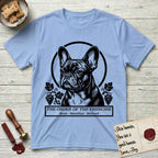 Holy Orders French Bulldog T-Shirt flat lay in Light Blue, featuring a bold black-and-white linocut saint-medallion portrait of a French Bulldog.