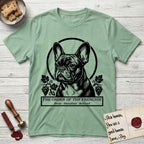 Holy Orders French Bulldog T-Shirt flat lay in Mint Green, featuring a bold black-and-white linocut saint-medallion portrait of a French Bulldog.