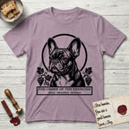Holy Orders French Bulldog T-Shirt flat lay in Paragon, featuring a bold black-and-white linocut saint-medallion portrait of a French Bulldog.