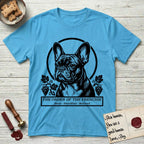 Holy Orders French Bulldog T-Shirt flat lay in Sky, featuring a bold black-and-white linocut saint-medallion portrait of a French Bulldog.